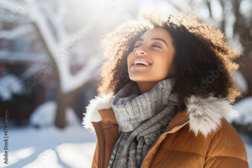 A Latin woman breathes calmly looking up enjoying winter season photo