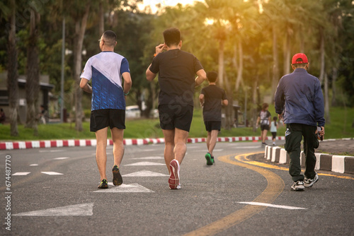 Healthy group of people jogging on track in park.  couple enjoying friend time at jogging park while running. together outdoor. healthy sport concept