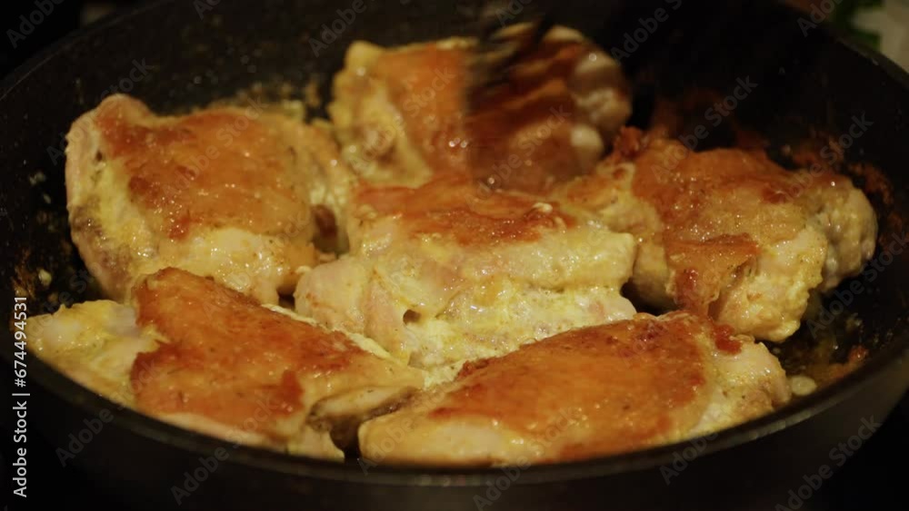 Marinated chicken thighs fried in a pan. Close-up of cooking fried chicken meat. Marinated chicken thighs fried in a pan. Close-up of cooking fried chicken meat.