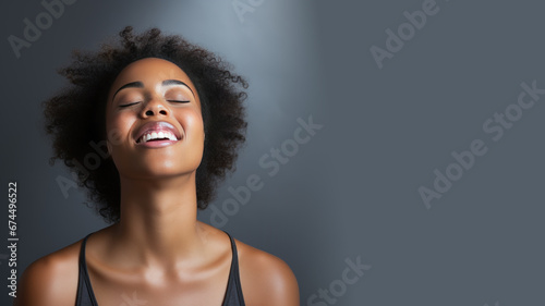 A African woman breathing calmly looking up isolated on gray background