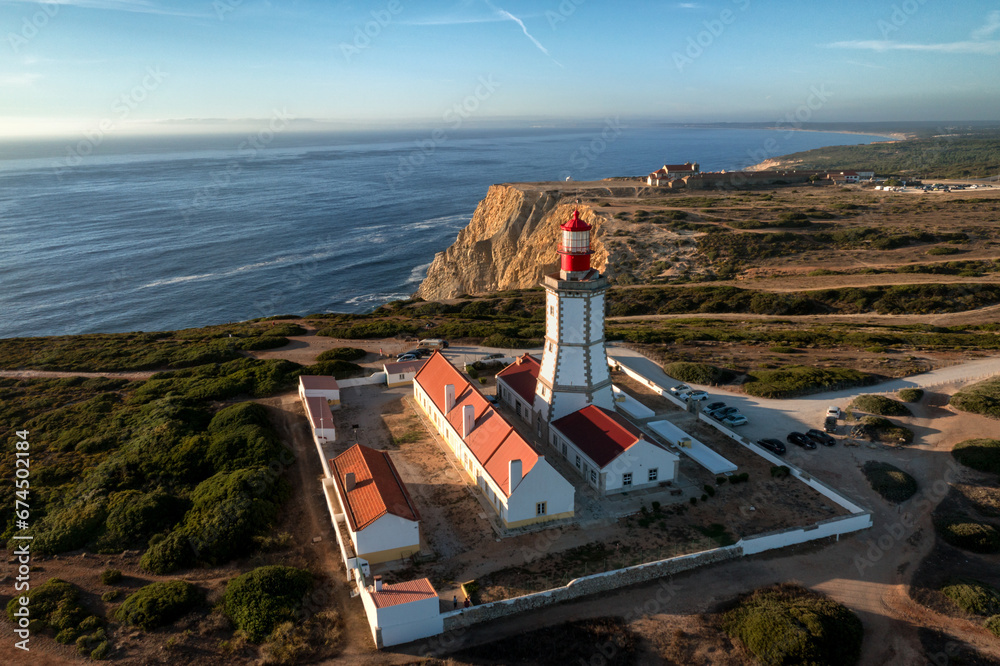 Beautiful view of lighthouse, cape Espichel at sunset and sea