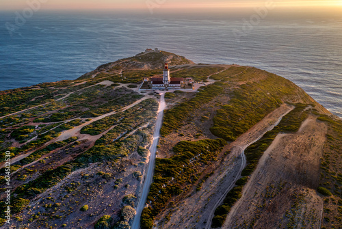 Obraz na płótnie Sunset view of lighthouse, cliffs and sea horizon, cape Espichel w salonie
