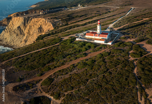 Obraz na płótnie Lighthouse on high cliffs of cape Espichel, Portugal, at sunset w salonie