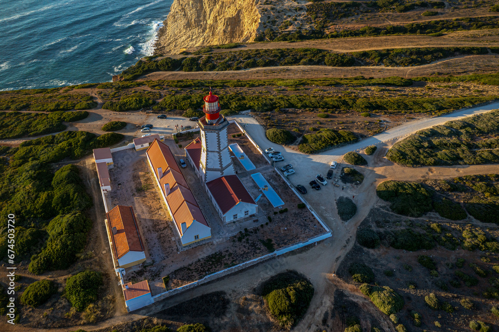 Beautiful drone view of lighthouse, cape Espichel at sunset, Portugal