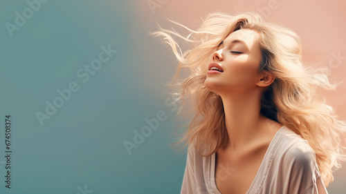 A blonde woman breathes calmly looking up isolated on pastel background