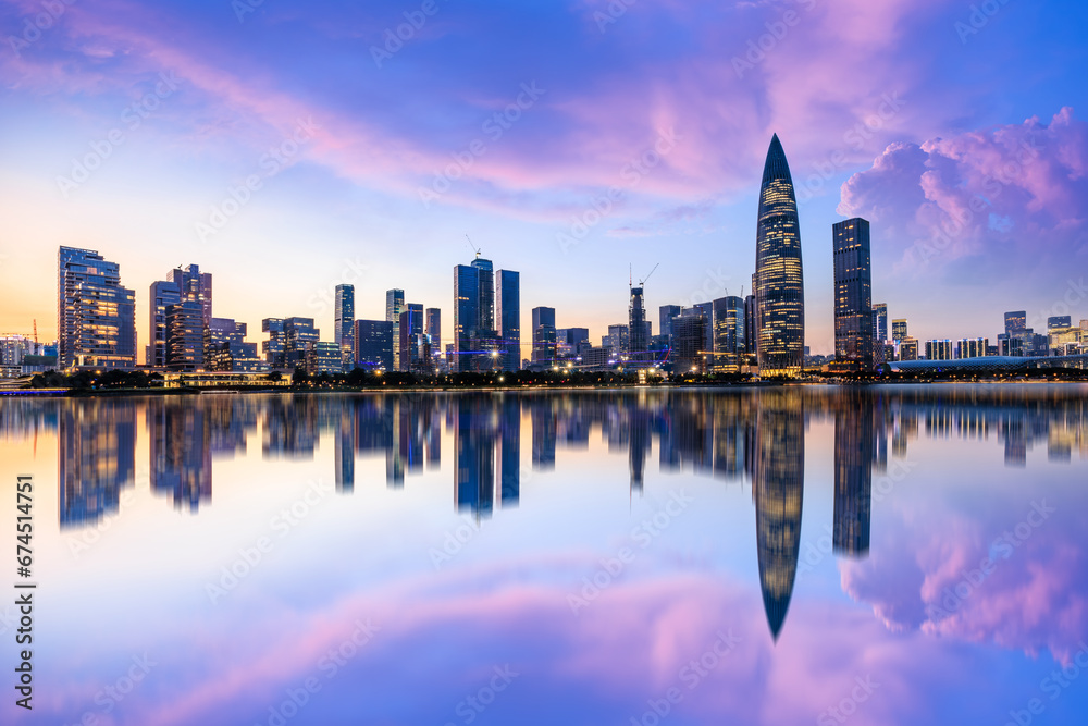 Shenzhen skyline and skyscrapers scenery at night, Guangdong Province, China. Modern city buildings and water reflection.
