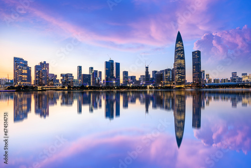 Shenzhen skyline and skyscrapers scenery at night, Guangdong Province, China. Modern city buildings and water reflection.