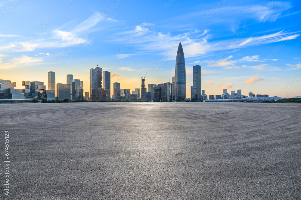 Asphalt road and urban skyline with modern buildings at sunset in Shenzhen, Guangdong Province, China.
