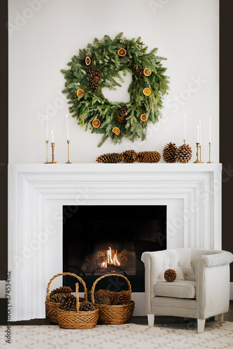 Stylish white interior with fireplace and  Christmas decorations. 