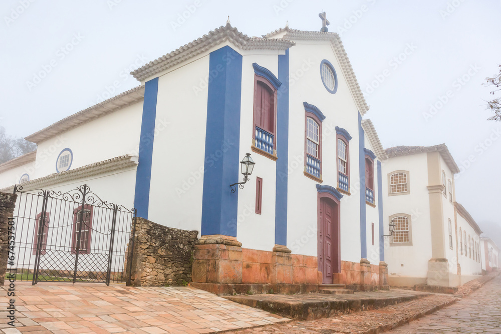 Church in the city of Tiradentes width under fog, tourist attraction of state Minas Gerais, Brazil