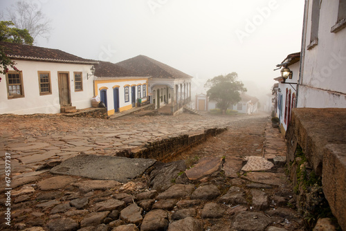 Fotografie Fog apparent on the stone streets and colonial houses in the historic city of Tiradentes, Minas Gerais, Brazil