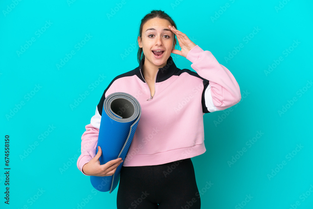 Sport Ukrainian woman going to yoga classes while holding a mat with surprise expression Sport Ukrainian woman going to yoga classes while holding a mat with surprise expression