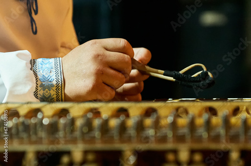 A musician plays the Belarusian tsymbaly during a live performance photo