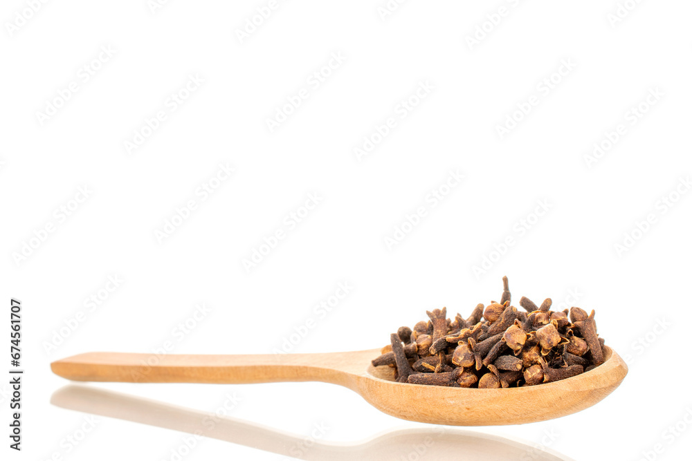 Dry aromatic cloves and with wooden spoon, macro, isolated on white background. Dry aromatic cloves and with wooden spoon, macro, isolated on white background.