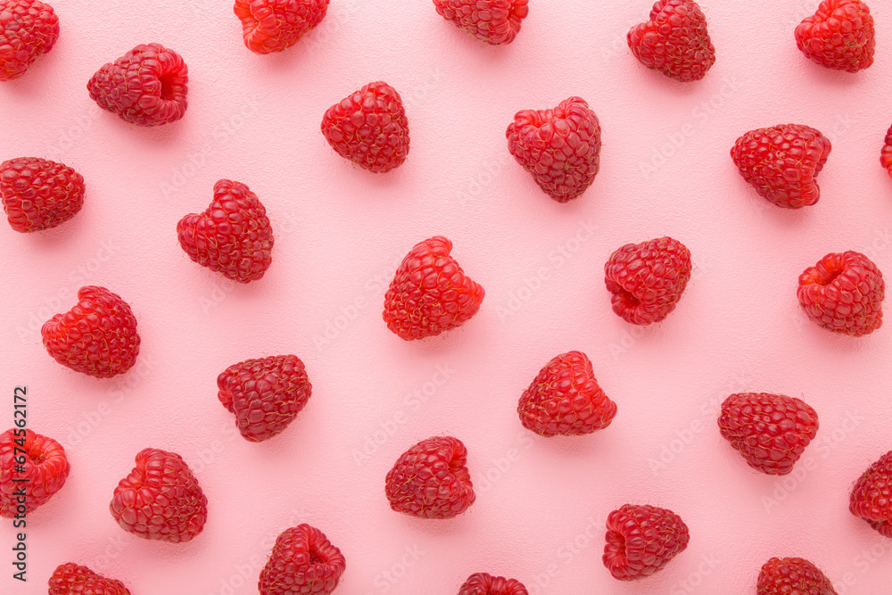 Fresh red raspberries on light pink table background. Pastel color. Berries pattern. Closeup. Top down view. Fresh red raspberries on light pink table background. Pastel color. Berries pattern. Closeup. Top down view.