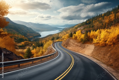 Beautiful Autumn highway with Fall foliage colors forest and lake river mountain in far distance. Autumn seasonal concept.