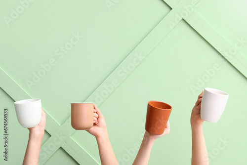 Four hands holding assorted...