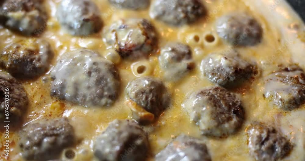 Meatballs are prepared in yellow sauce, close-up, slowmotion. Turkish cuisine, healthy food, delicious lunch Meatballs are prepared in yellow sauce, close-up, slowmotion. Turkish cuisine, healthy food, delicious lunch