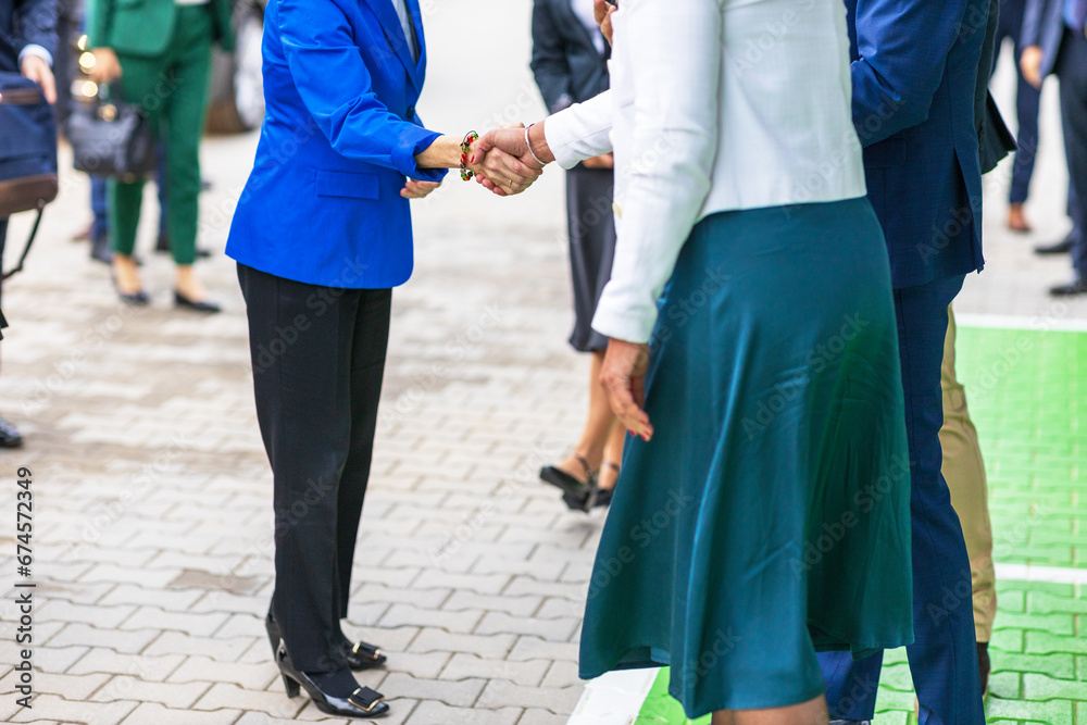 Female politicians or business persons welcome handshake before meeting