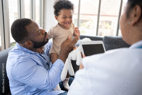 Pediatrics doctor with stethoscope for lungs or chest checkup for examining cute little girl in medical healthcare hospital or clinic. Doctor check Heart And Lungs for Smiling African American Baby.