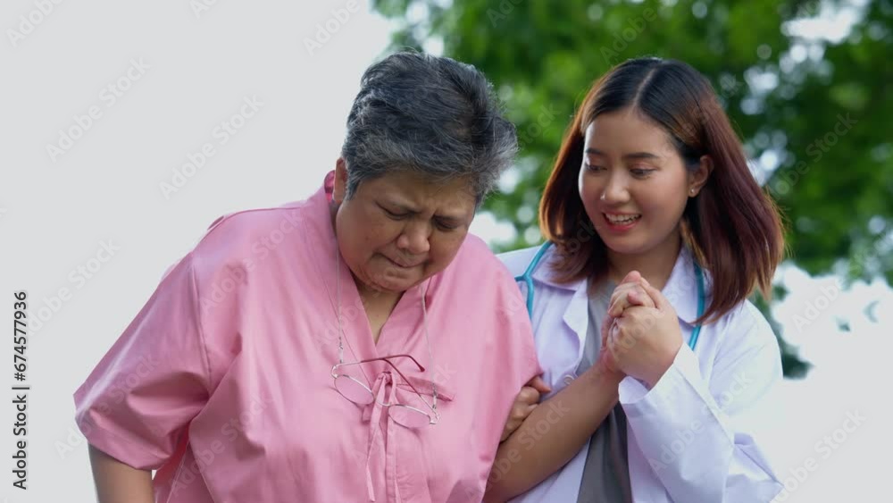 An old elderly Asian woman Do physical therapy and walking in the garden with her doctor. Concept of happy retirement With care from a caregiver and Savings and senior health insurance, health care An old elderly Asian woman Do physical therapy and walking in the garden with her doctor. Concept of happy retirement With care from a caregiver and Savings and senior health insurance, health care