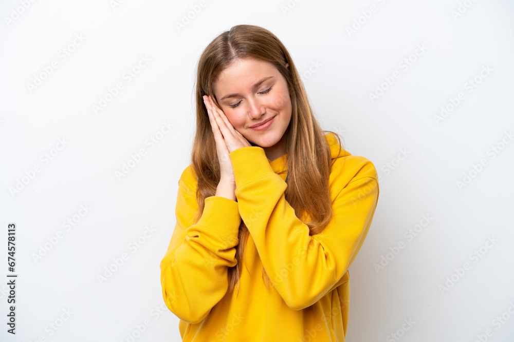 Young caucasian woman isolated on white background making sleep gesture in dorable expression Young caucasian woman isolated on white background making sleep gesture in dorable expression