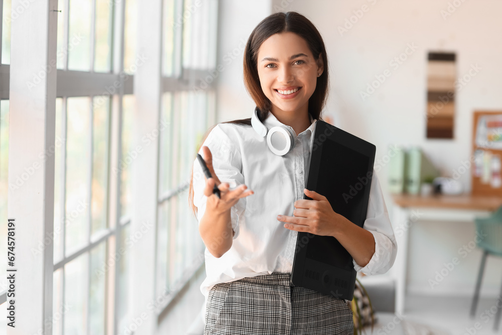 Obraz premium Female interior designer with graphic tablet in office