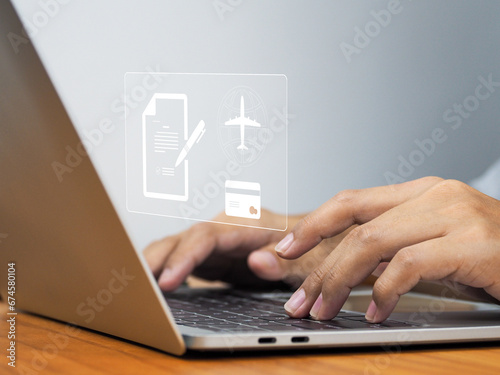 Online Flight Ticket Payment, Travelers prepare for their travel by booking tickets and paying with credit card on laptop on the weekend