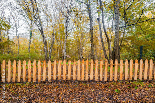 Fototapeta Naklejka Na Ścianę i Meble -  Wooden fence in the autumn forest