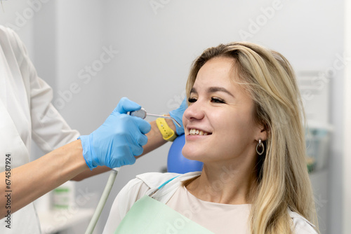 female dentist using water and air syringe tool  process of treatment in dental clinic