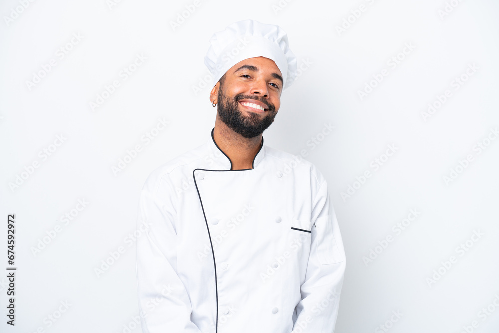 Young Brazilian chef man isolated on white background laughing Young Brazilian chef man isolated on white background laughing