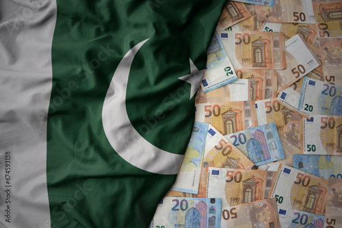 colorful waving national flag of pakistan on a euro money background. finance concept