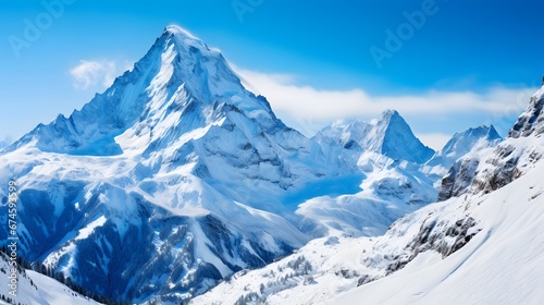 Panoramic view of the snow-capped mountains and blue sky