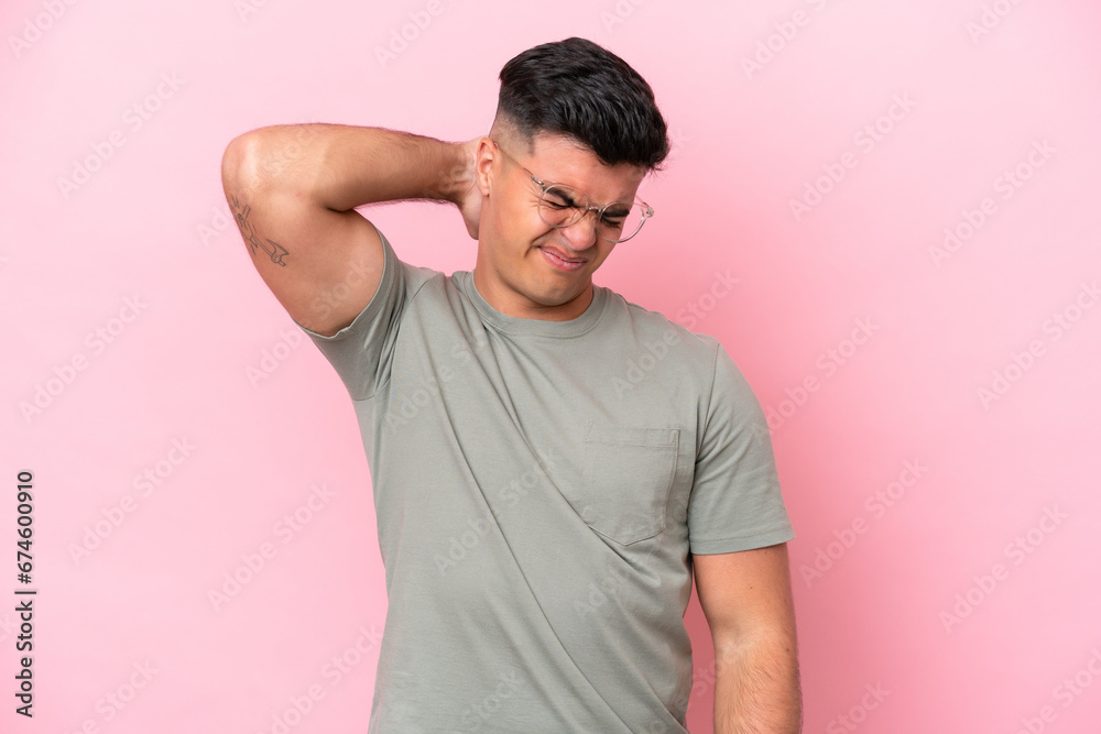 Young caucasian handsome man isolated on pink background with neckache Young caucasian handsome man isolated on pink background with neckache