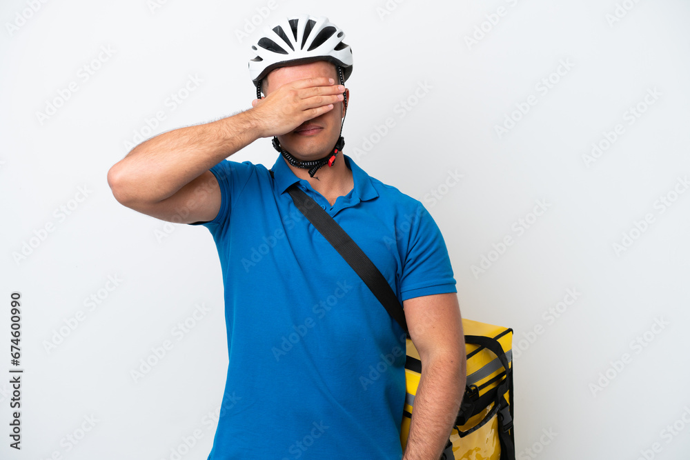 Young caucasian man with thermal backpack isolated on white background covering eyes by hands. Do not want to see something Young caucasian man with thermal backpack isolated on white background covering eyes by hands. Do not want to see something