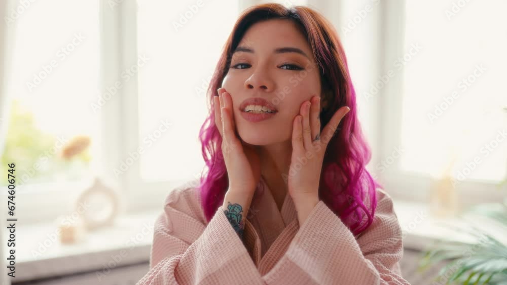 Portrait of happy smiling attractive asian woman wearing bathrobe touching perfect skin looking at camera. Advertising of bodycare spa procedures antiage delicate dry skin care products concept. Portrait of happy smiling attractive asian woman wearing bathrobe touching perfect skin looking at camera. Advertising of bodycare spa procedures antiage delicate dry skin care products concept.