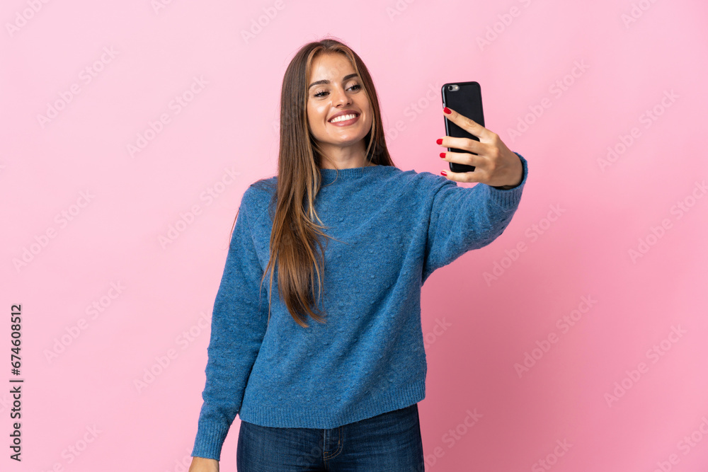 Young Uruguayan woman isolated on pink background making a selfie Young Uruguayan woman isolated on pink background making a selfie