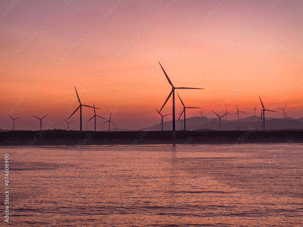 wind turbines at sunset，