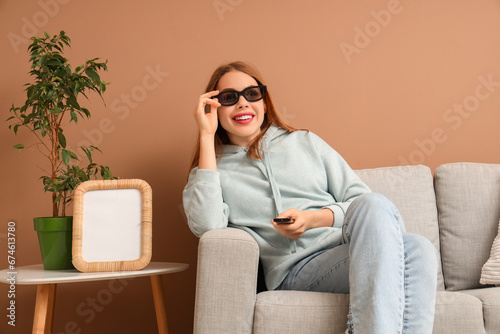 Pretty young woman with TV ...