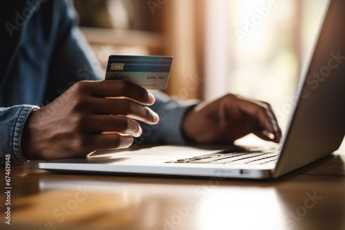 An individual using a desktop computer to make an online purchase with a credit card photo