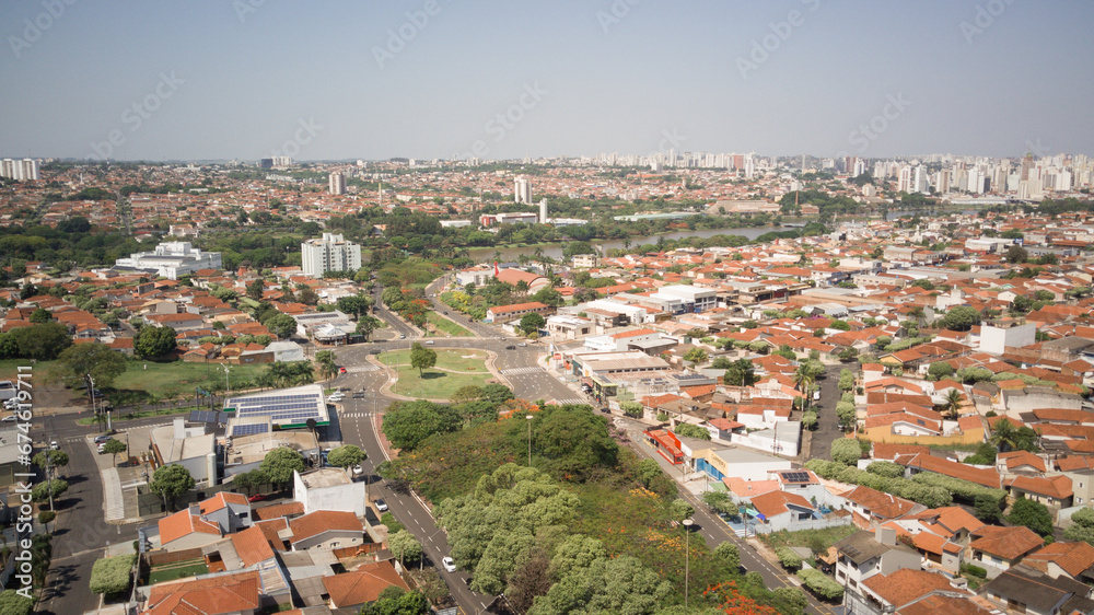 Panoramic aerial view of the city of the municipal dam and the Preto River in the city of Sao Jose do Rio Preto on a sunny day, with houses and tourist attractions of the city in the foreground