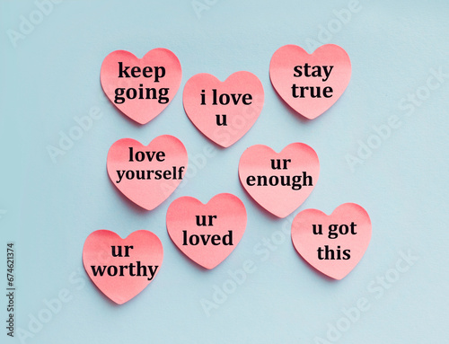 Фотография Motivational love quotes written on heart sticky notes