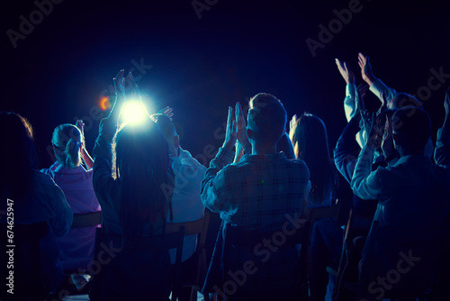 Group of of different people applauding, attending concert, stand up show, cheerfully spending time with jokes and funny stories. Concept of entertainment, fun and joy, concert, performance