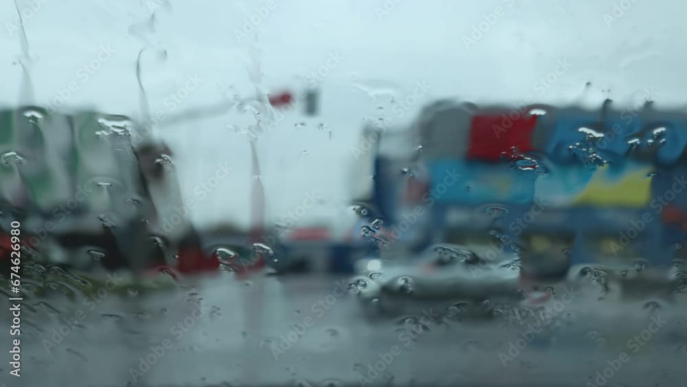 View from a car window on a cloudy autumn day of traffic along a city street