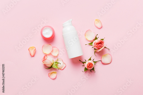 Fancy healthcare bottles for cream with rose flower. Natural oranic spa cosmetics concept. Mockup, template, Top view