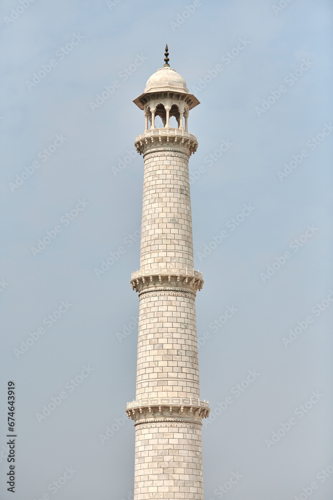 Minaret of Taj Mahal white marble mausoleum landmark in Agra, Uttar Pradesh, India, white tower