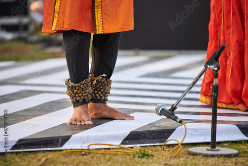 Small bells Ghungroo on male feet of indian dancer for ancient ethnic Kathak dance photo