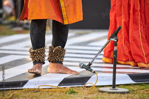 Small bells Ghungroo on male feet of indian dancer for ancient ethnic Kathak dance photo