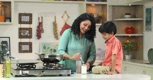 Mother giving her son glass of milk
