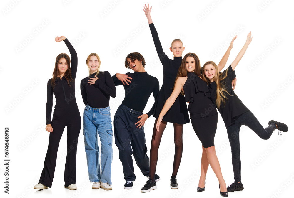 Group portrait of charming, cheerful people, teenagers wearing smart casual outfits posing on white studio background. Concept of beauty, youth, emotions, fashion, style, modelling. Copy space for ad.